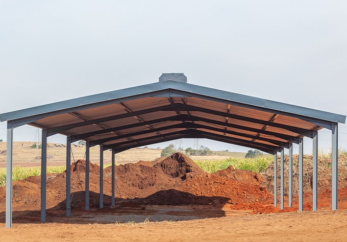 Metal buildings and roofing supplier in Zachary, LA Walker Metals. Image of new agricultural shed open barn steel metal building.
