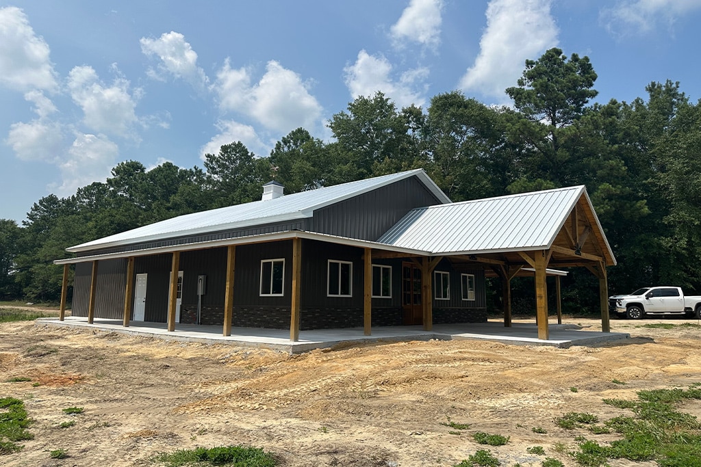 A pole barn in Baker, LA with a metal roof and a wooden porch.