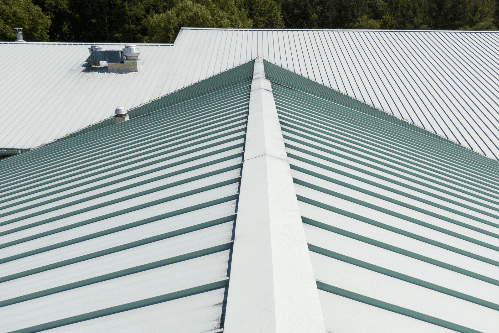 metal roof installation, metal roofing in Walker, LA at Walker metals. Green standing seam metal roofing on a large commercial building.
