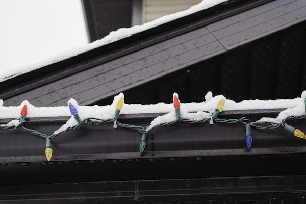Lights on a roof at christmas showing the result of learning how to attach christmas lights to a metal roof